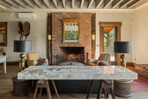 a dining room with table chairs and a fireplace