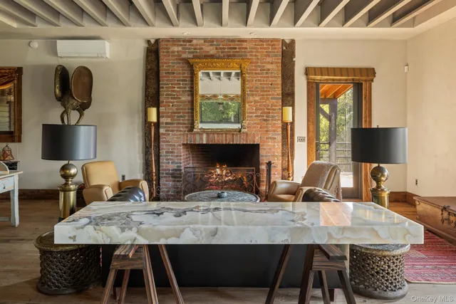 a dining room with table chairs and a fireplace