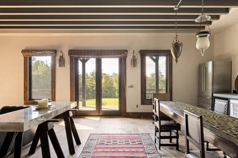 a view of a dining room with furniture and a large window