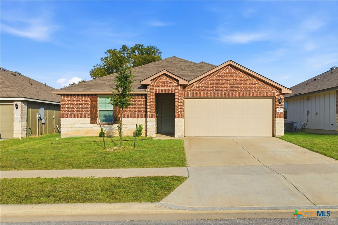 9506 Falme Lane Killeen, TX 76542 - Photo 1 of 27 a front view of a house with a garden and yard