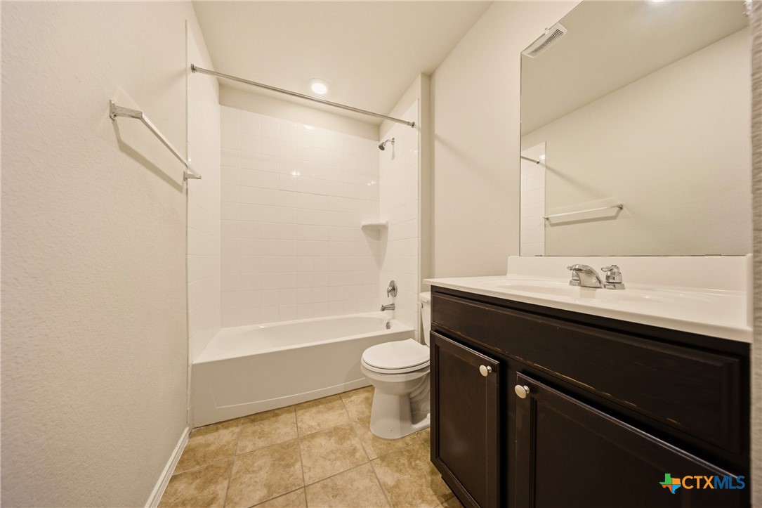 9506 Falme Lane Killeen, TX 76542 - Photo 19 of 27 a bathroom with a sink a toilet and shower