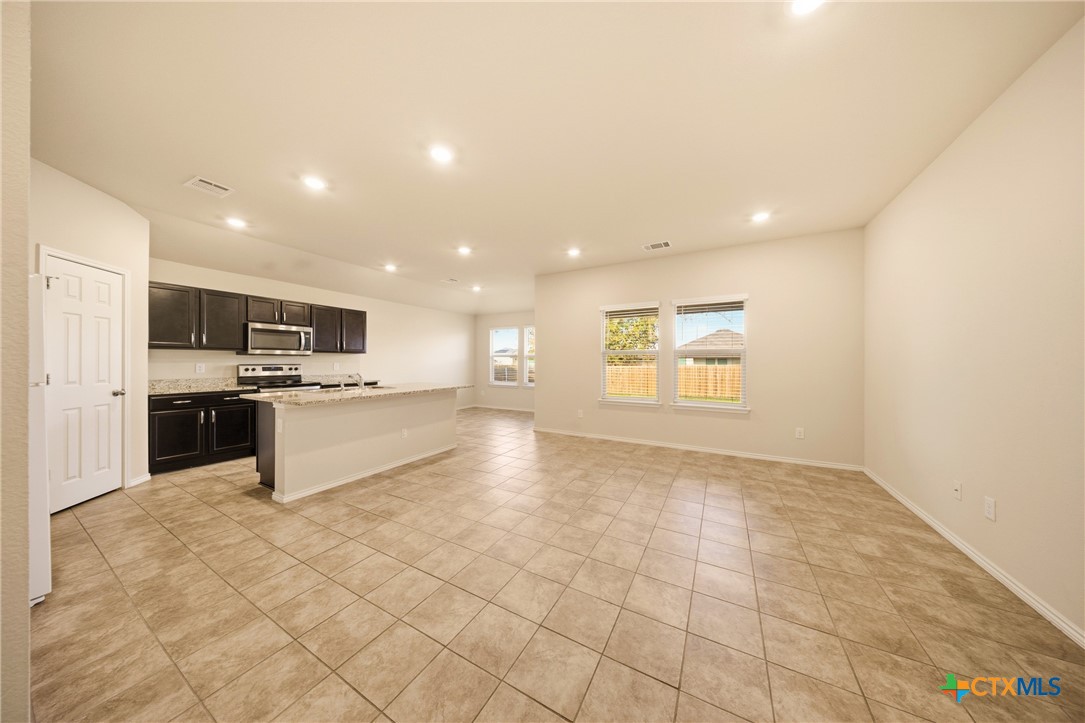 9506 Falme Lane Killeen, TX 76542 - Photo 3 of 27 a large kitchen with kitchen island a sink a stove a counter top and oven