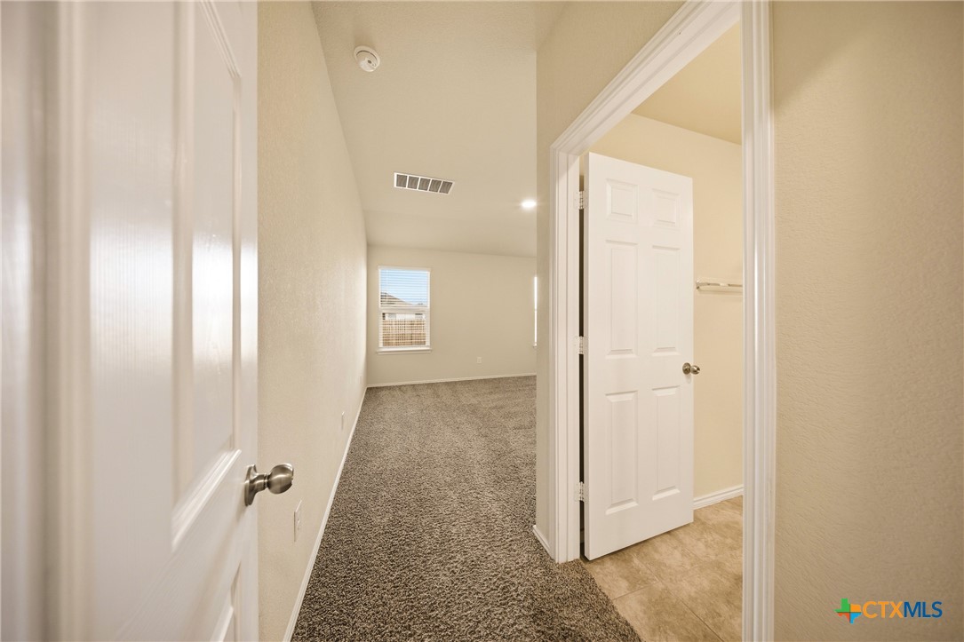 9506 Falme Lane Killeen, TX 76542 - Photo 9 of 27 a view of a hallway with wooden floor and closet