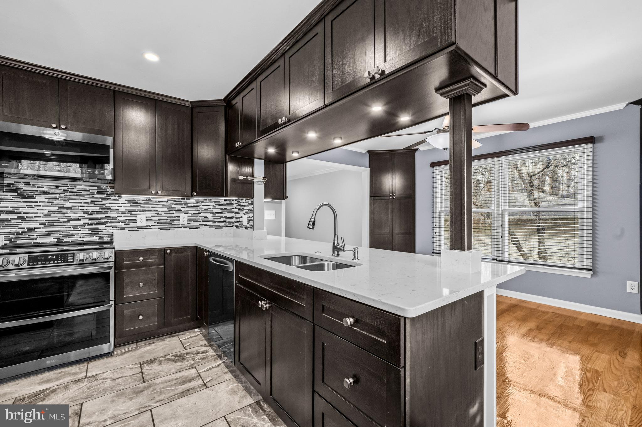 7201 Neaptide Lane Burke, VA 22015 - Photo 12 of 75 a kitchen with a sink stainless steel appliances and cabinets
