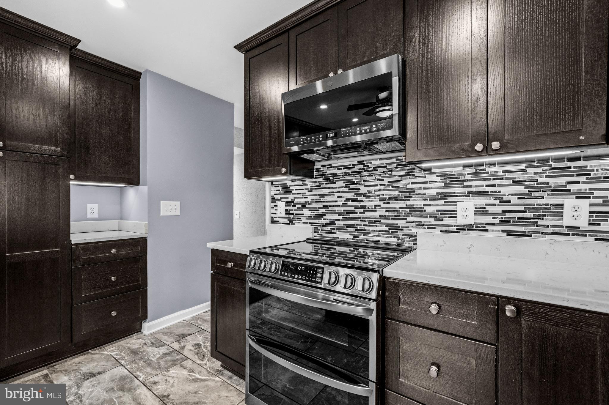 7201 Neaptide Lane Burke, VA 22015 - Photo 16 of 75 a kitchen with a stove and a microwave
