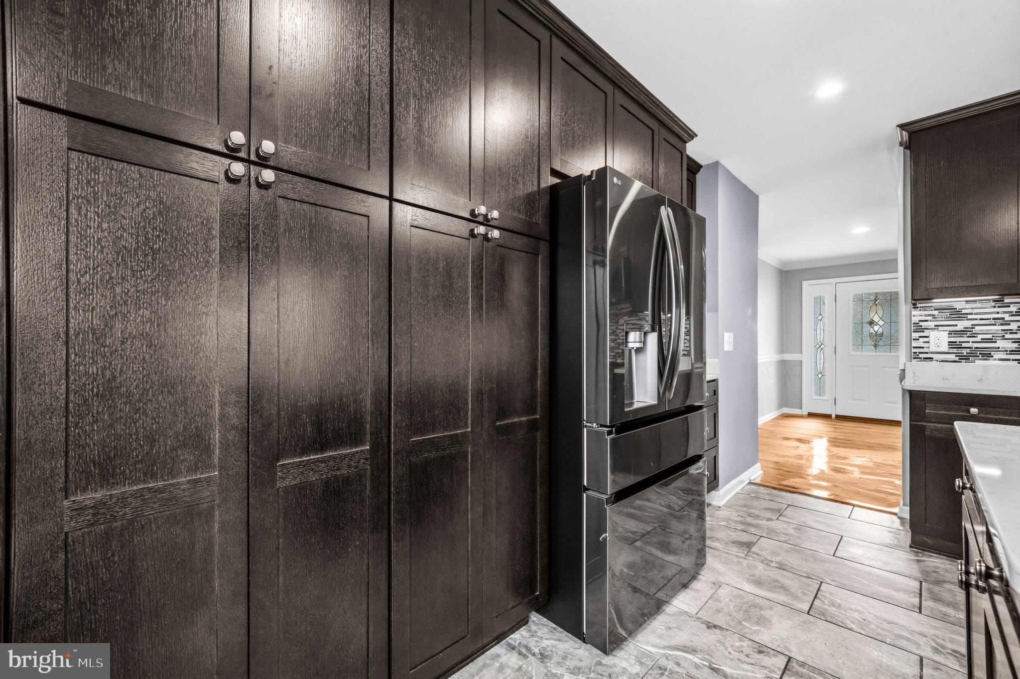 7201 Neaptide Lane Burke, VA 22015 - Photo 17 of 75 a view of a refrigerator in kitchen and a glass door shower
