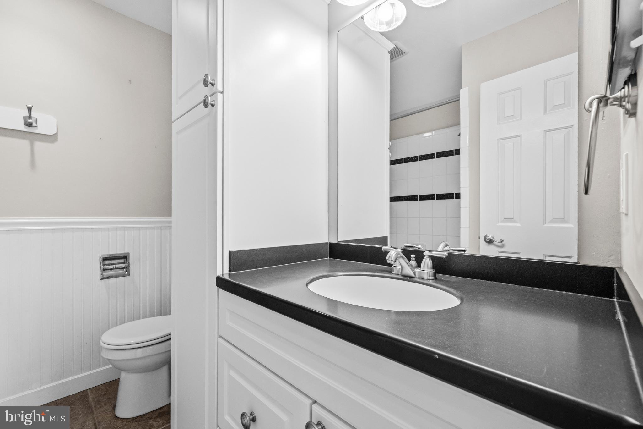 7201 Neaptide Lane Burke, VA 22015 - Photo 30 of 75 a bathroom with a sink and a mirror