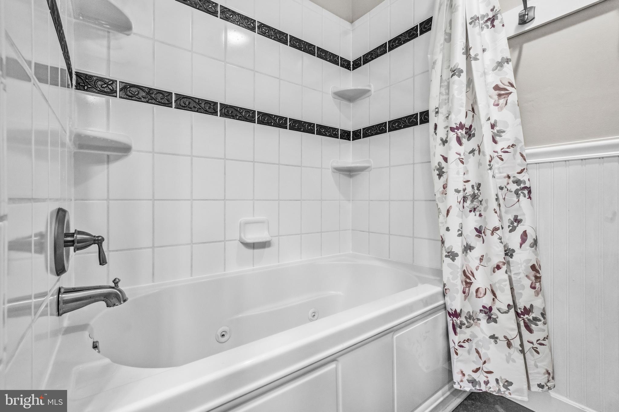 7201 Neaptide Lane Burke, VA 22015 - Photo 31 of 75 a bathroom with a bathtub and shower