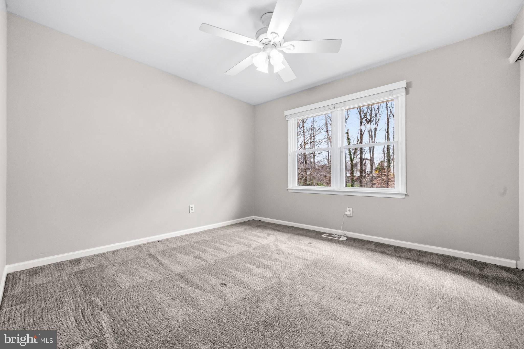 7201 Neaptide Lane Burke, VA 22015 - Photo 32 of 75 an empty room with windows and fan