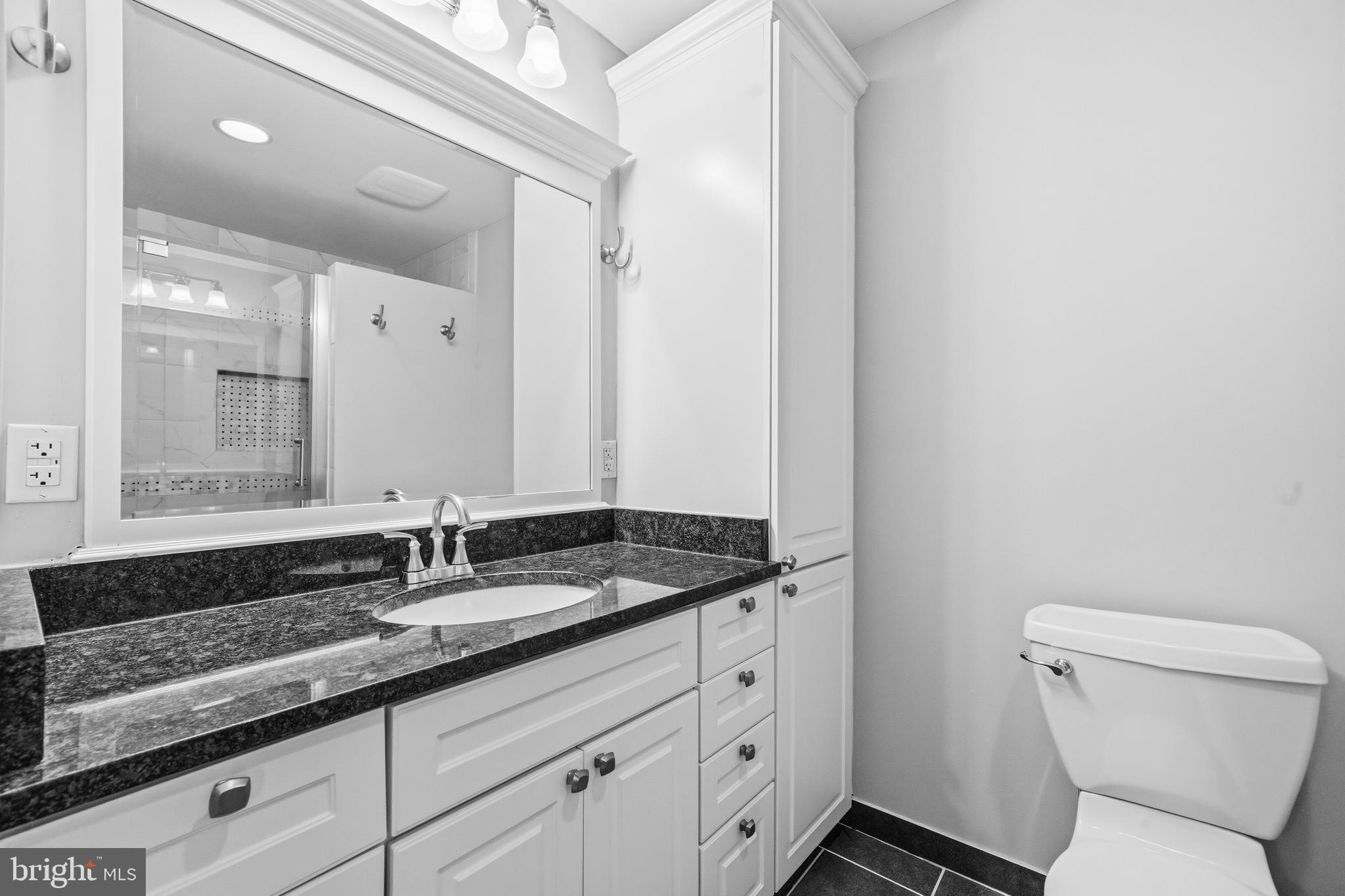 7201 Neaptide Lane Burke, VA 22015 - Photo 38 of 75 a bathroom with a granite countertop sink a toilet and a mirror