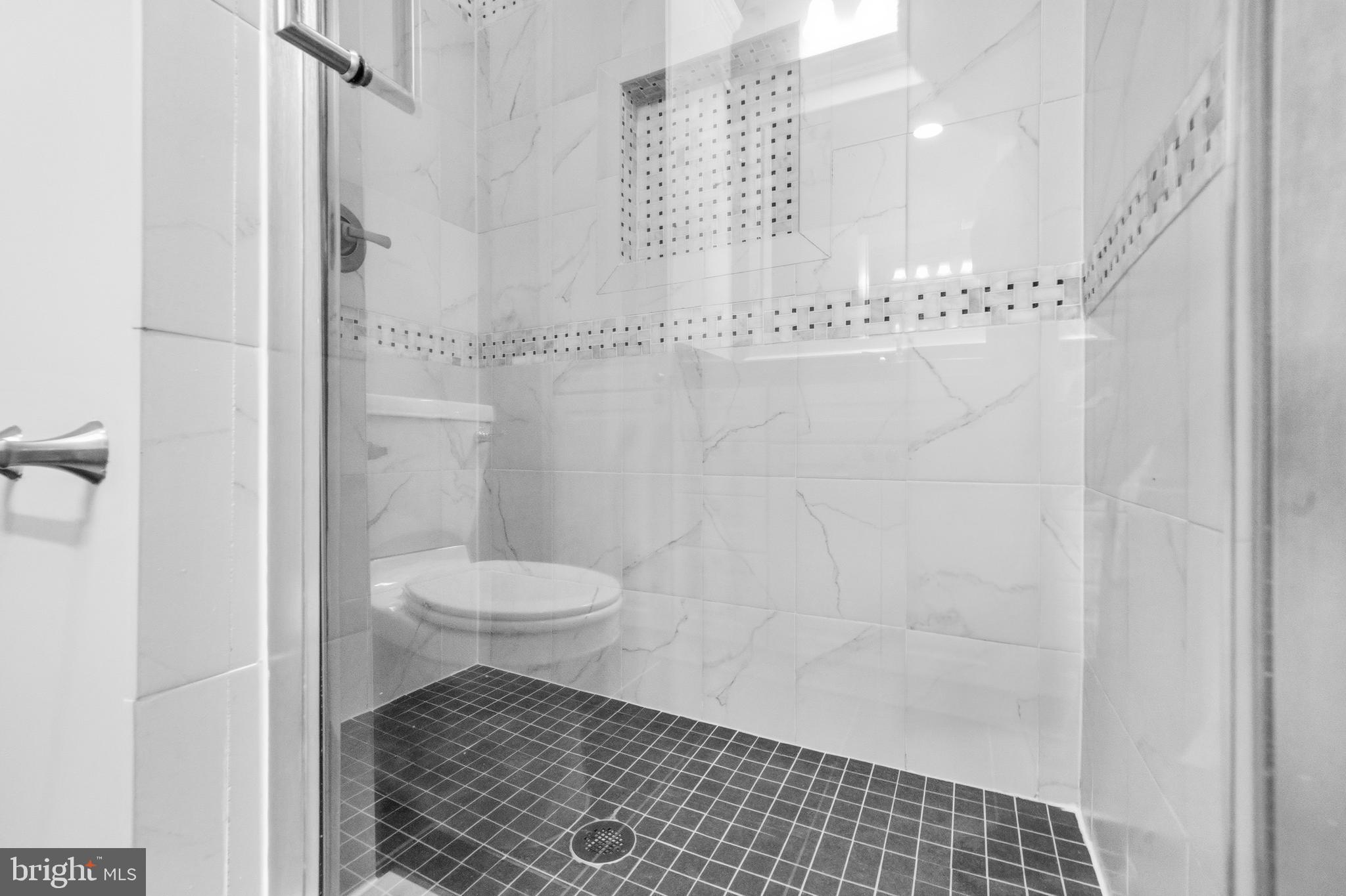 7201 Neaptide Lane Burke, VA 22015 - Photo 39 of 75 a bathroom with a toilet and a shower
