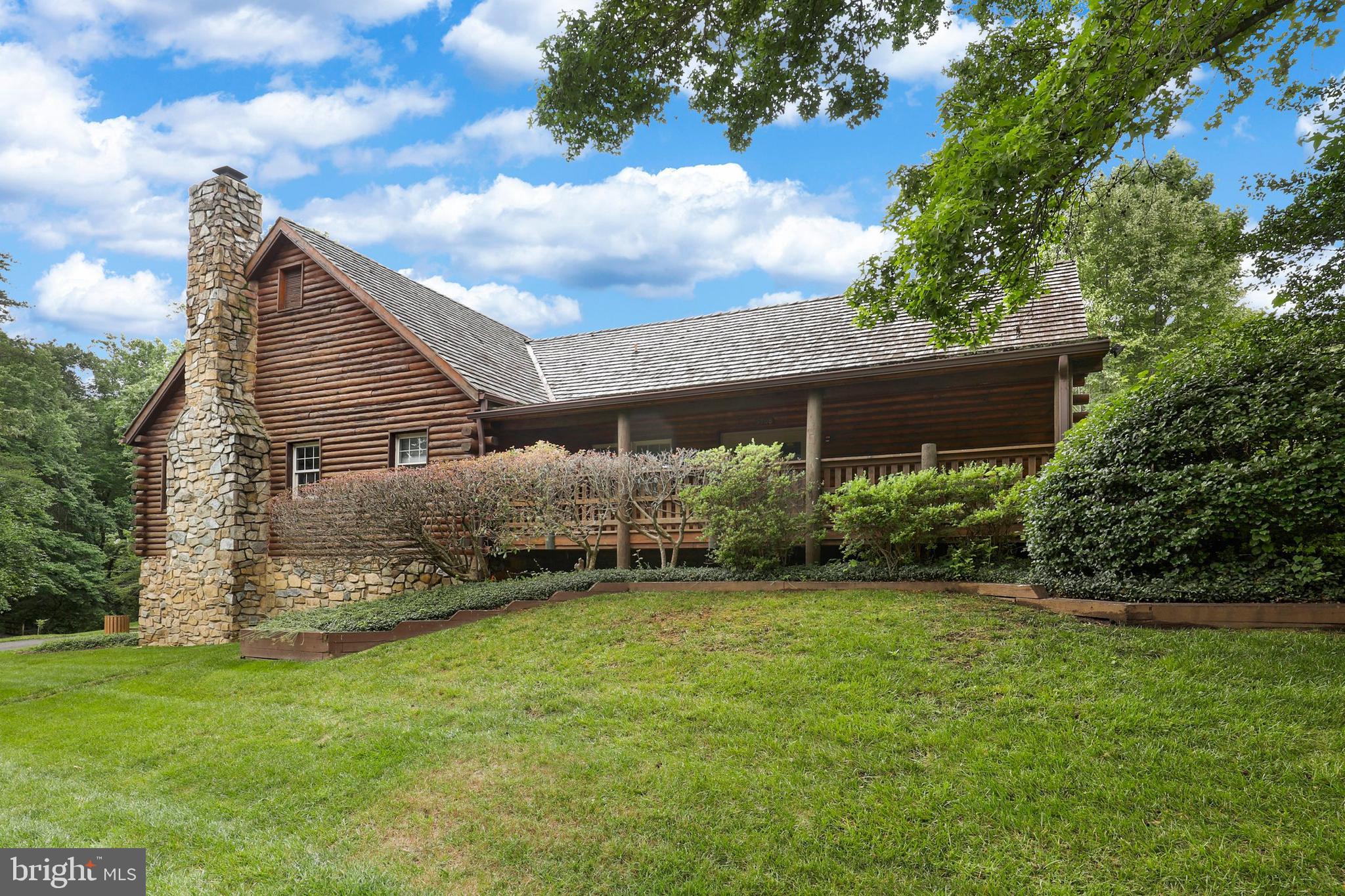 7201 Neaptide Lane Burke, VA 22015 - Photo 63 of 75 a backyard of a house with plants and large tree