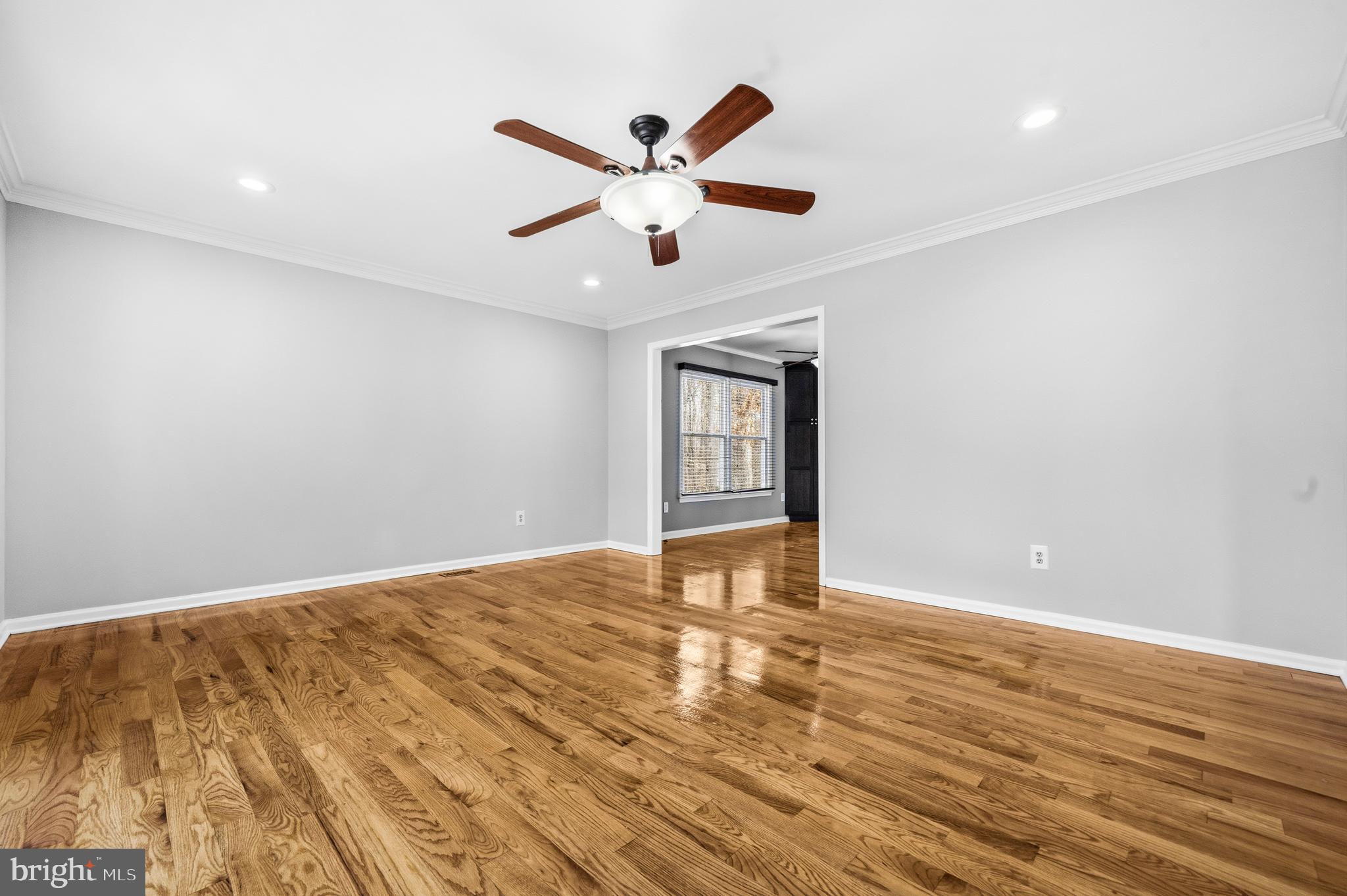 7201 Neaptide Lane Burke, VA 22015 - Photo 8 of 75 a view of an empty room with window and wooden floor