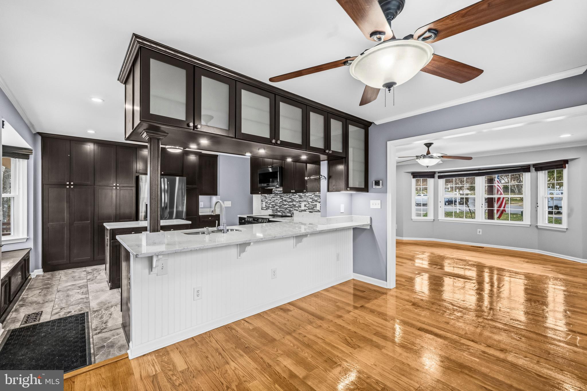 7201 Neaptide Lane Burke, VA 22015 - Photo 10 of 75 a kitchen with stainless steel appliances granite countertop a sink cabinets and wooden floor