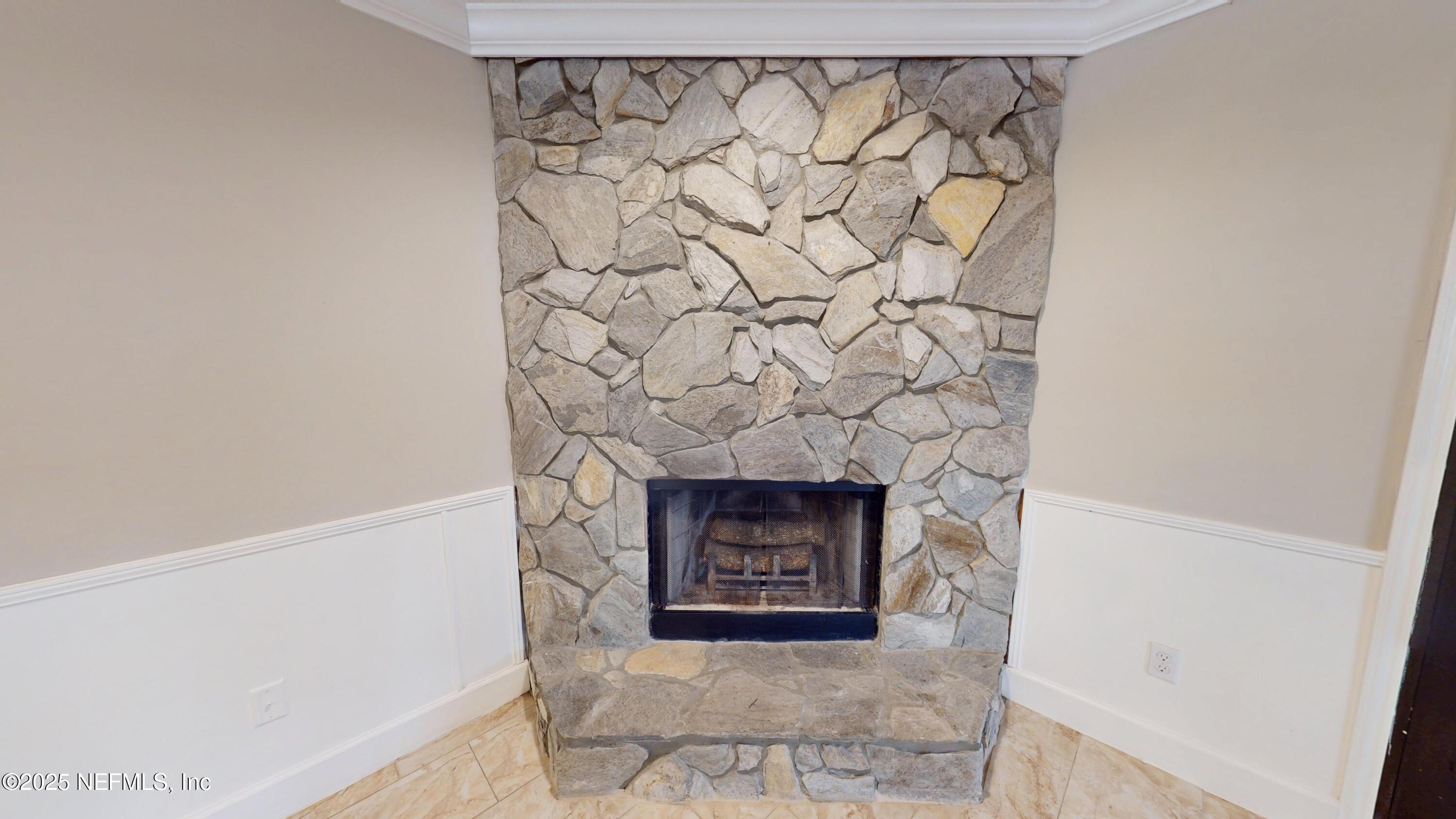 4402 Peppermill Place Jacksonville, FL 32257 - Photo 11 of 26 a stone house with a fireplace