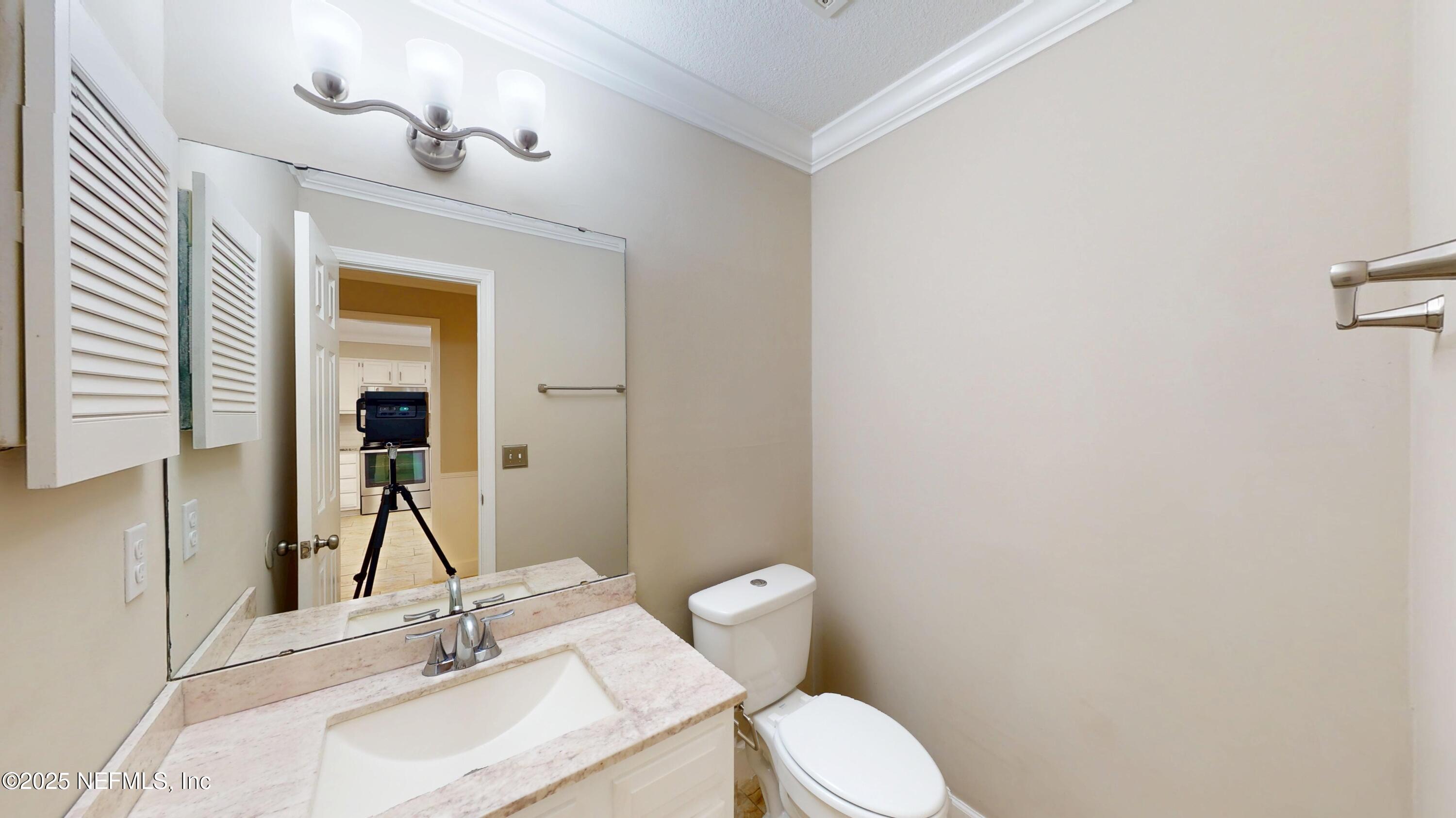 4402 Peppermill Place Jacksonville, FL 32257 - Photo 14 of 26 a bathroom with a sink vanity mirror and toilet