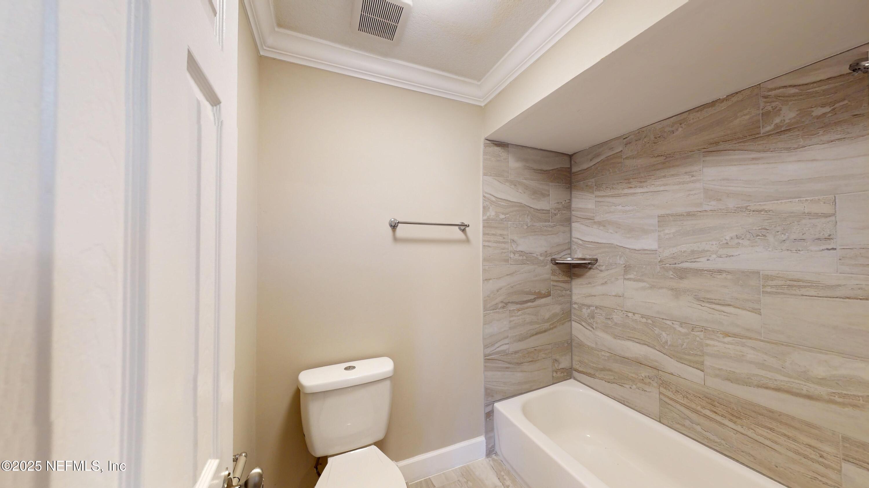 4402 Peppermill Place Jacksonville, FL 32257 - Photo 20 of 26 a bathroom with a toilet and shower