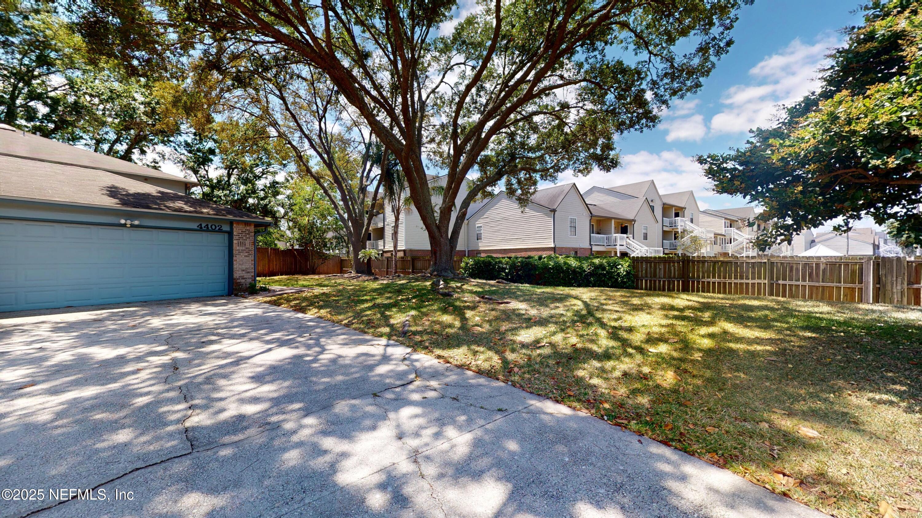 4402 Peppermill Place Jacksonville, FL 32257 - Photo 25 of 26 a view of backyard of house with trees