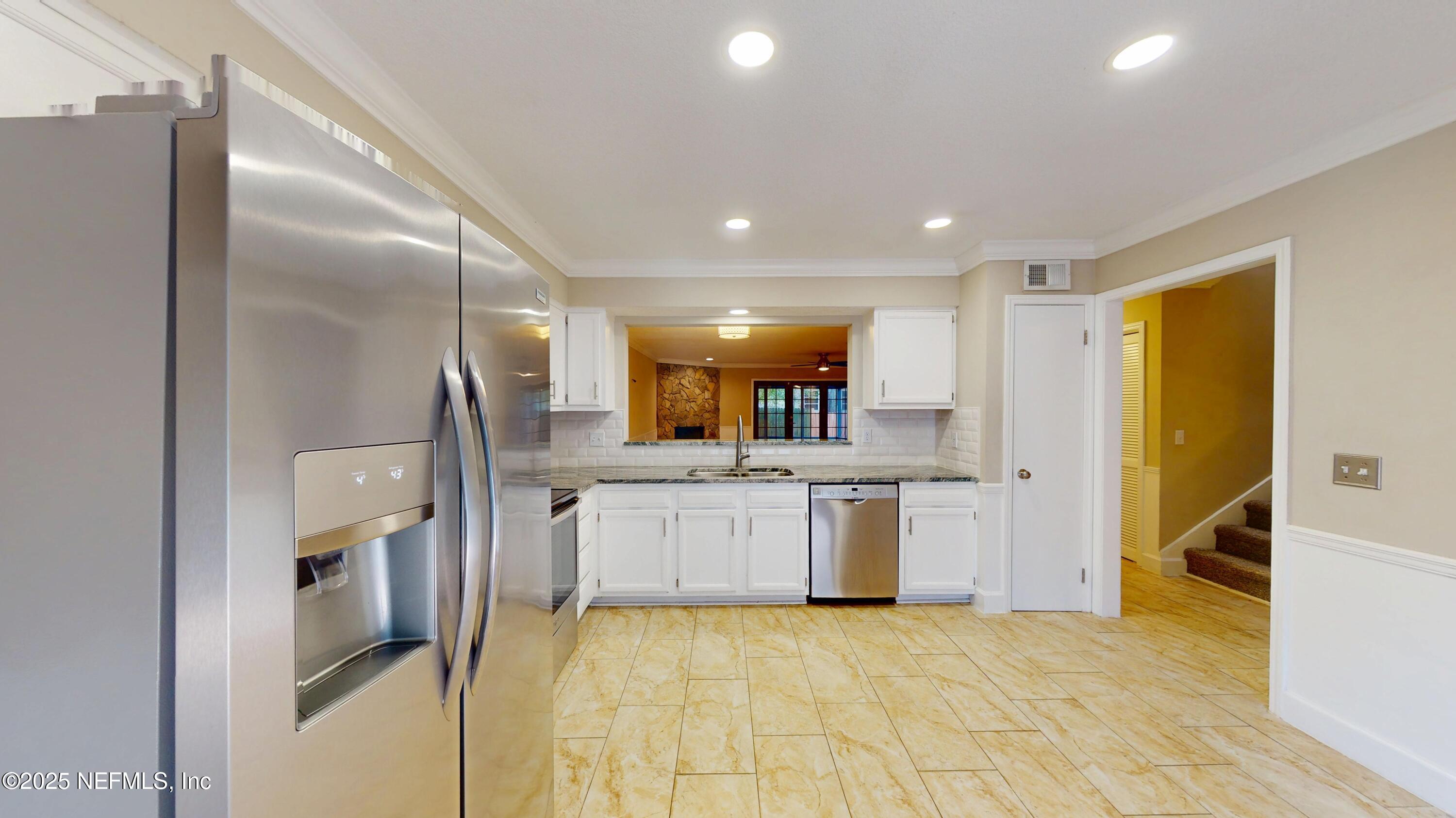 4402 Peppermill Place Jacksonville, FL 32257 - Photo 6 of 26 a large kitchen with stainless steel appliances kitchen island granite countertop a refrigerator and a sink