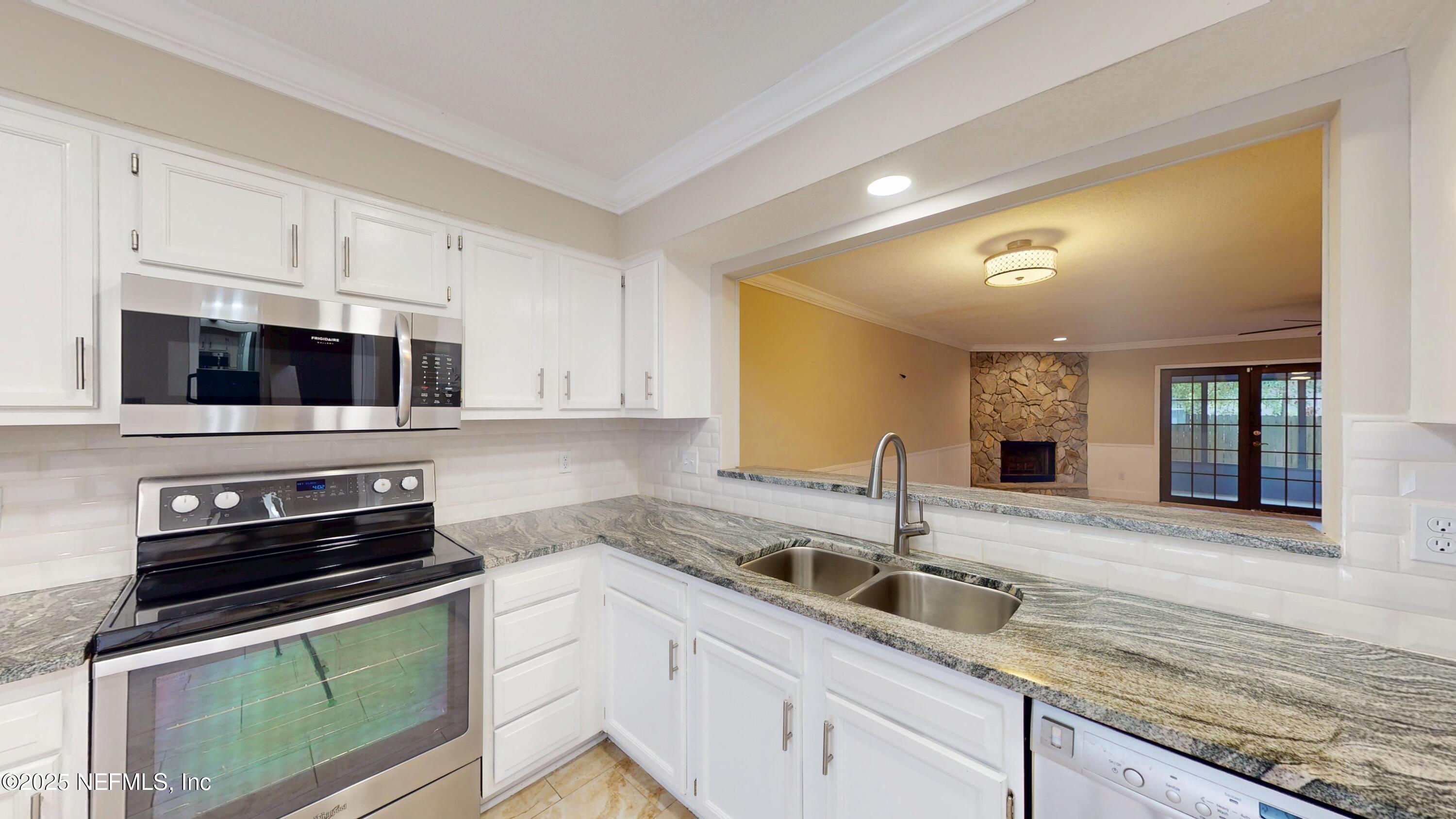 4402 Peppermill Place Jacksonville, FL 32257 - Photo 7 of 26 a kitchen with stainless steel appliances granite countertop a sink and a stove
