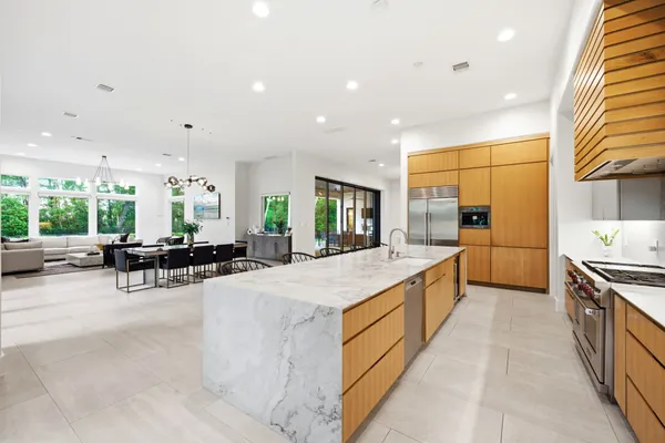 a kitchen with kitchen island a counter top and stainless steel appliances