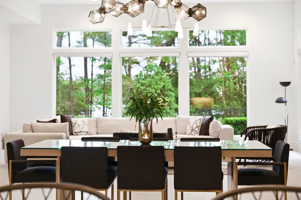 a dining room with furniture a large window and a potted plants