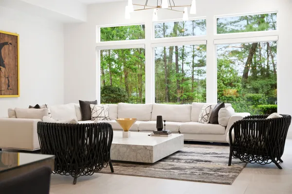 a living room with furniture and large windows