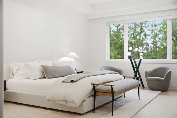 a bedroom with a bed and a couch with window