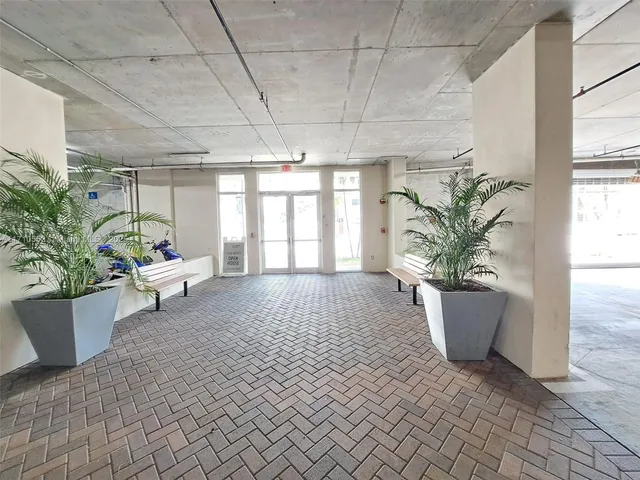 a view of small space with wooden floor and a window