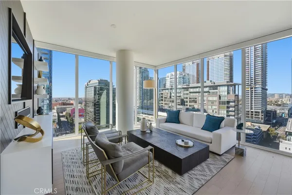 a living room with furniture and a floor to ceiling window
