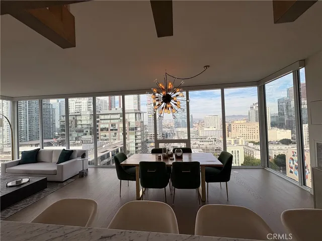 a living room with furniture and floor to ceiling windows