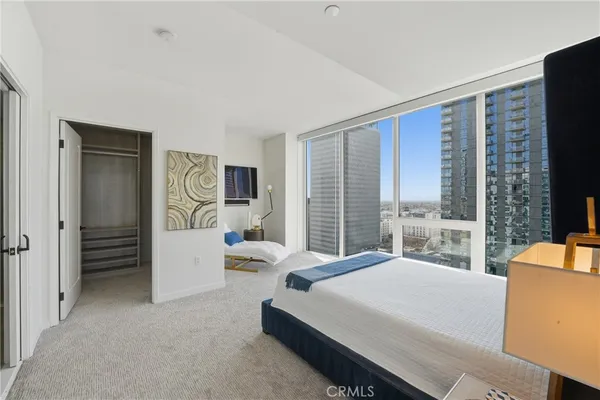 a bedroom with furniture and large windows