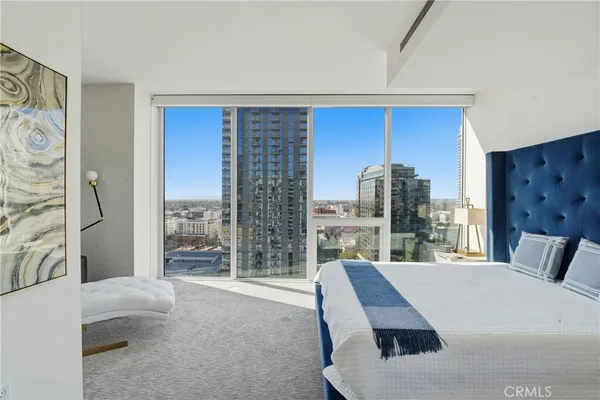 a large bedroom with a large window and a bed