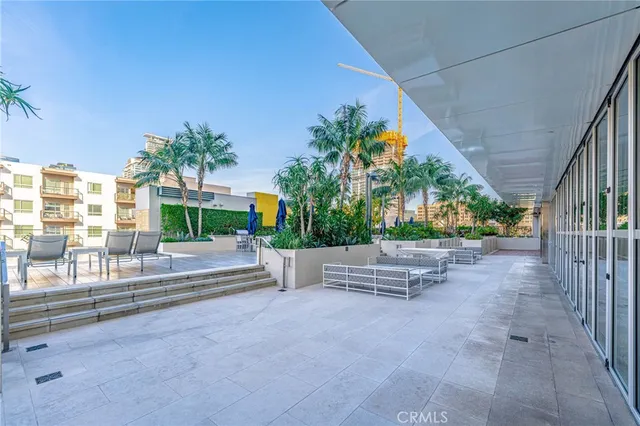 a view of a patio with a table and chairs and potted plants