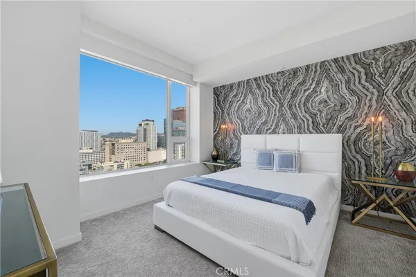 a bedroom with a large bed and a window