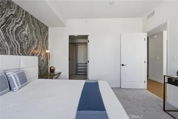 a bedroom with a bed and a mirror