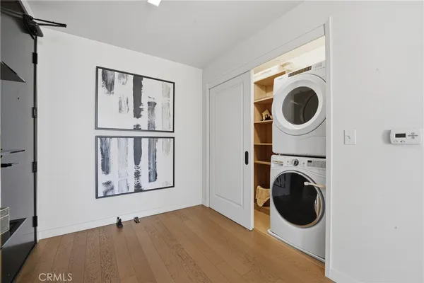 a view of a bedroom with washer and dryer