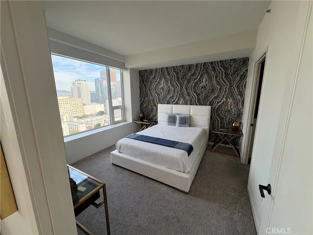 a bedroom with a bed and window