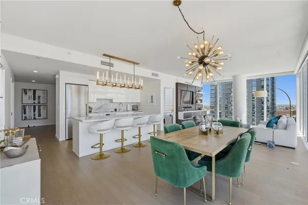 a view of a dining room with furniture and chandelier