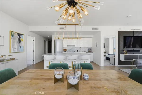 a living room with furniture and a chandelier