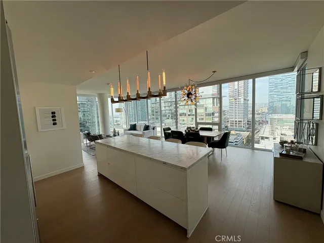 a living room with furniture and large windows