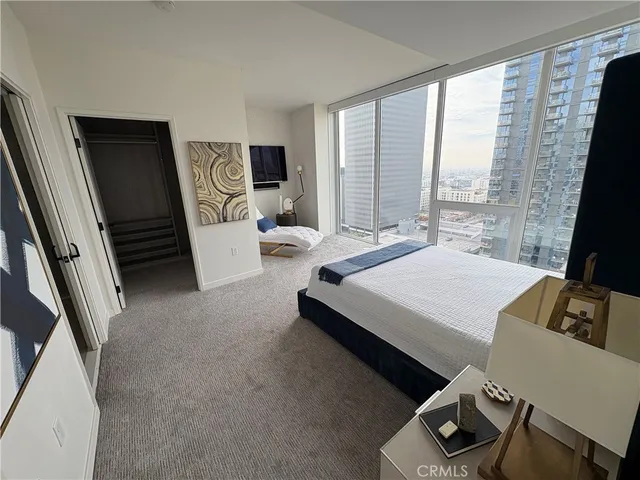 a bed room with a bed and a television