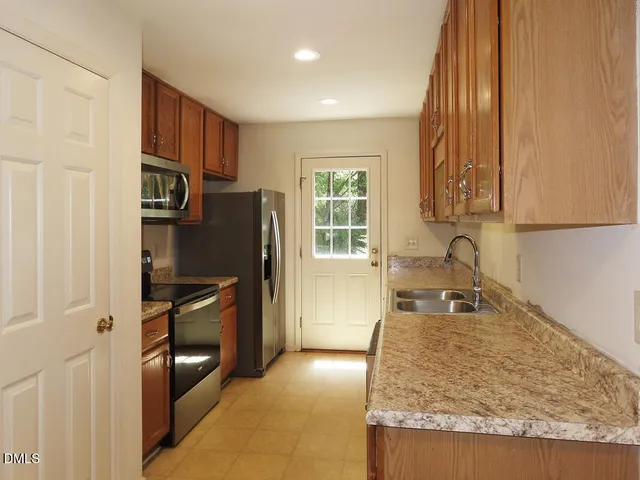 a kitchen with refrigerator and window