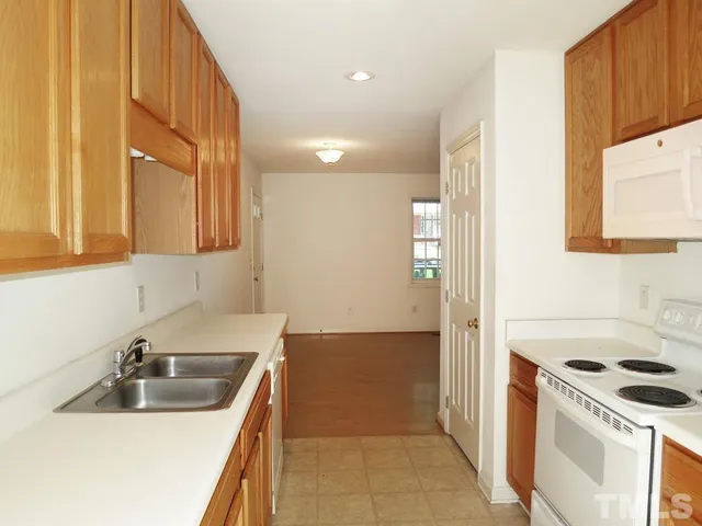 a kitchen that has a sink and a stove