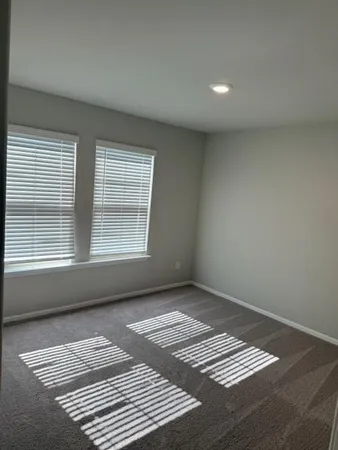 a view of a room with wooden floor and windows