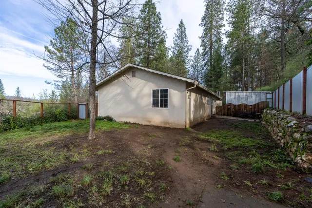 a view of a house with yard and a garden