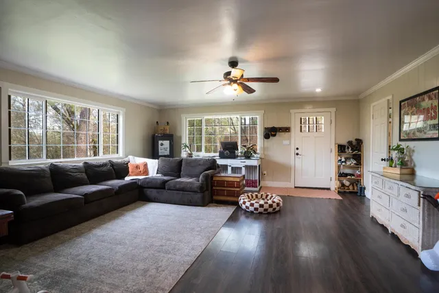 a living room with furniture and wooden floor