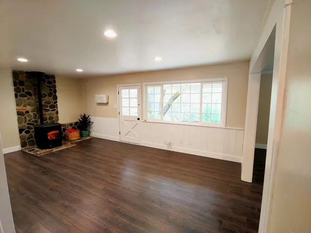 a view of a room with wooden floor and window