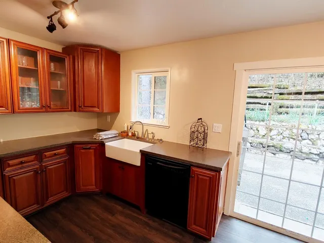 a kitchen with stainless steel appliances granite countertop wooden cabinets a sink and dishwasher