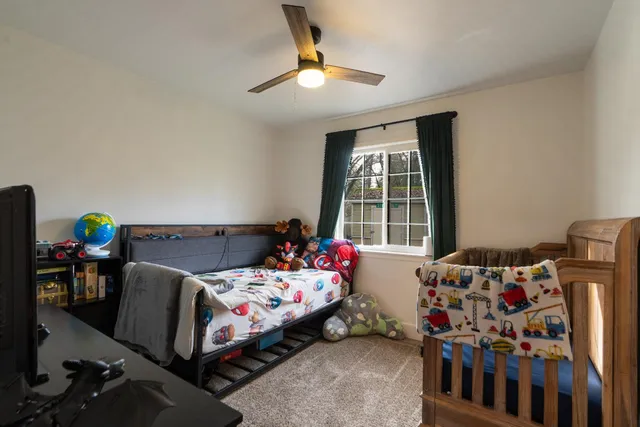 a bedroom with bed and a window